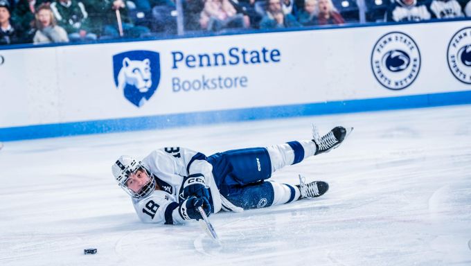 Aiden Fink falling to the ice against Michigan State