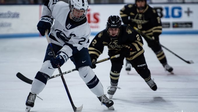 Lyndie Lobdell carrying the puck through neutral ice on her backhand