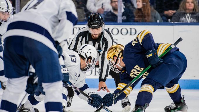 Danny Dzhaniyev taking a faceoff against Notre Dame