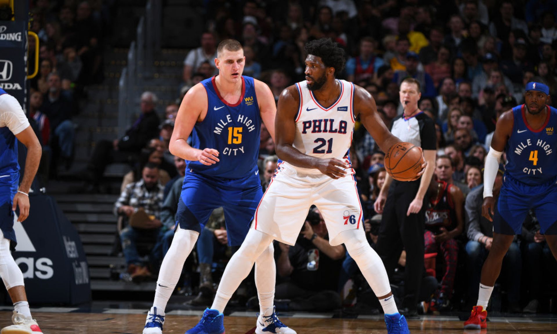 Joel Embiid backing down Nikola Jokic