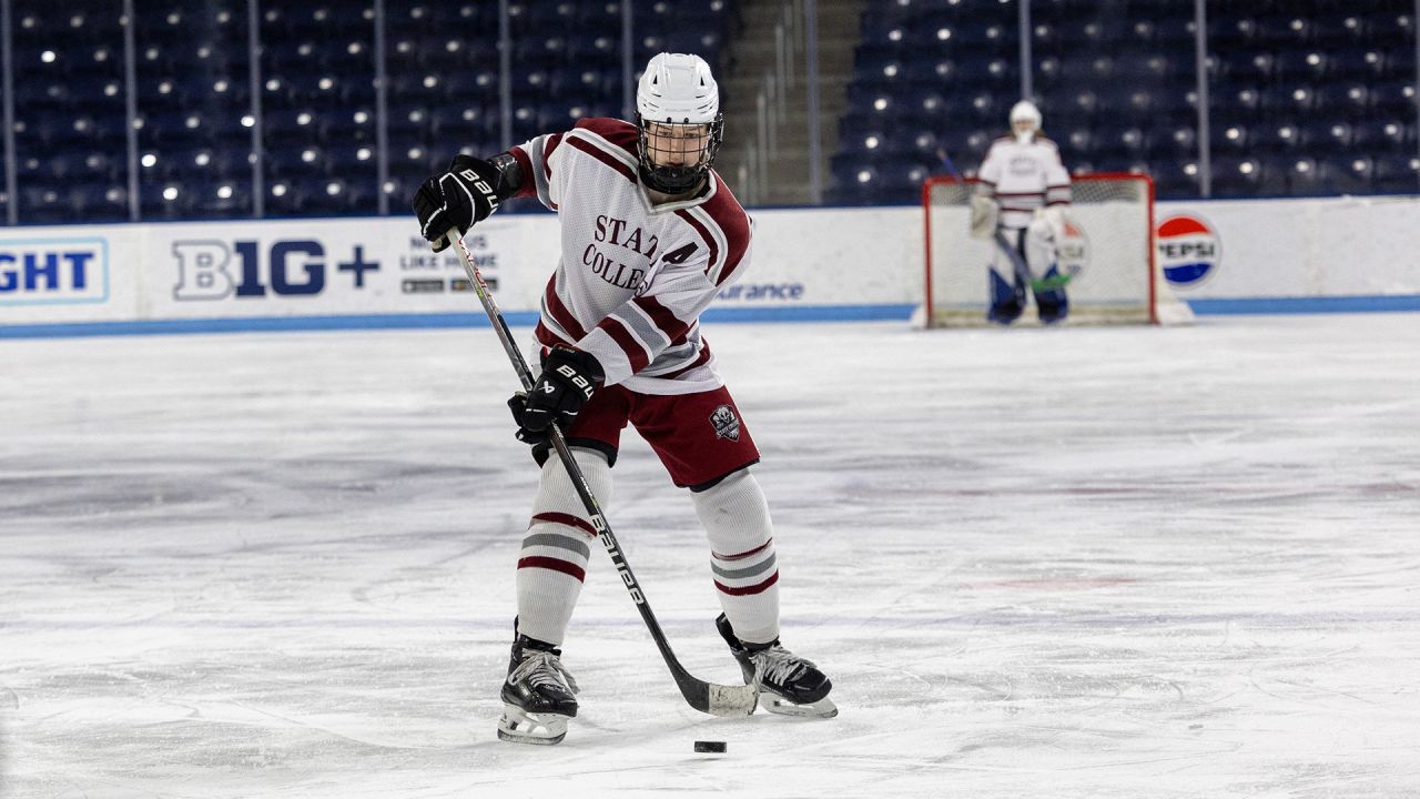 State College club hockey player moving the puck down the ice.