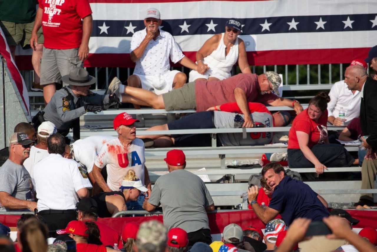 People lay on bleachers amidst a crowd in the bleachers