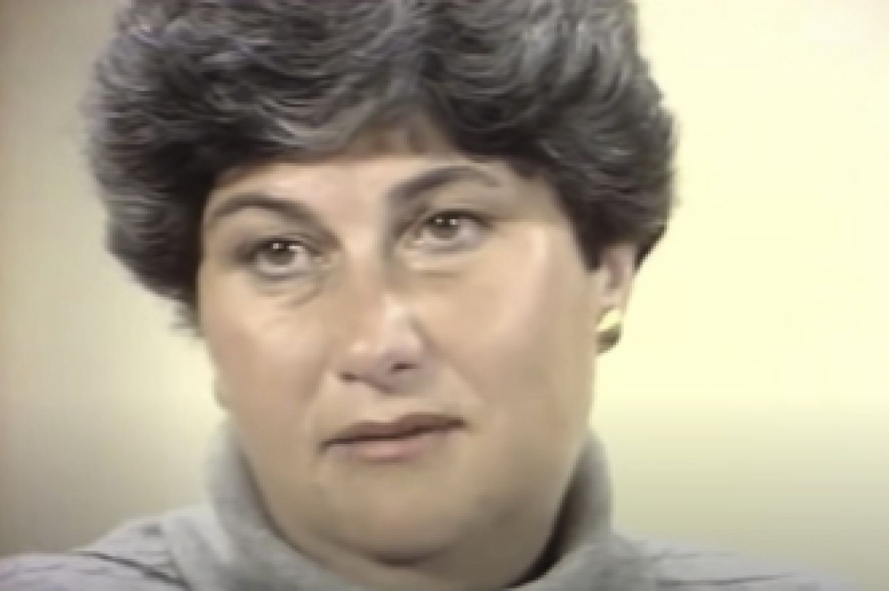 Headshot of a woman with dark highlighted hair.