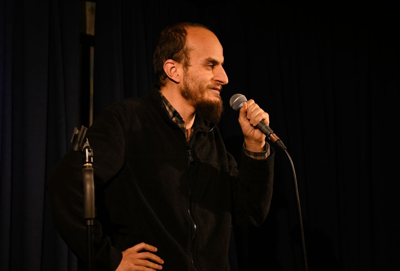 A comedian on stage performs as part of TuzBiber Stand Up