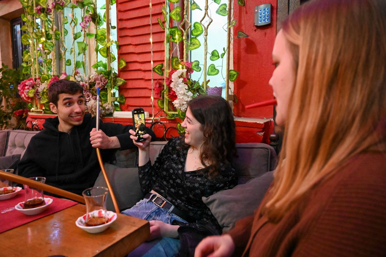 Nick Stonesifer takes a picture with friends in Harab'be Cafe in Fatih, Istanbul. (Photo by Courtney Benedetto)