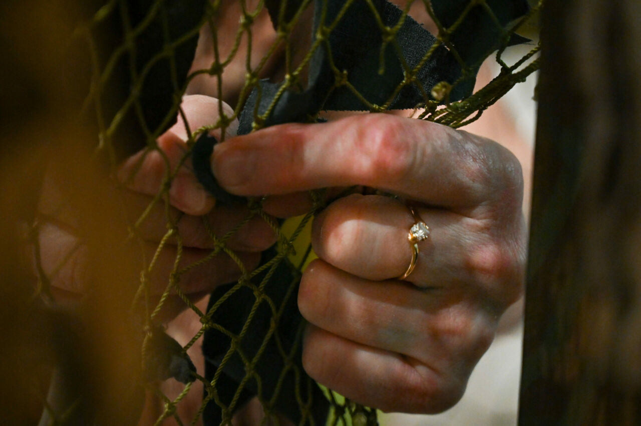 Close up of a person's left hand making a net.