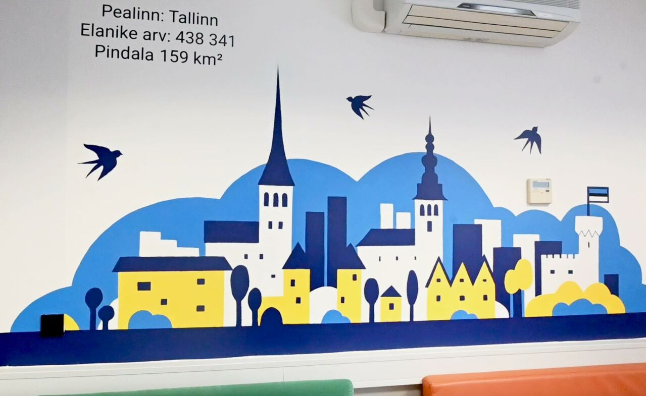 A mural of a skyline on a school wall