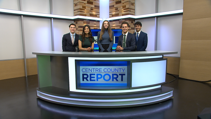 Five Centre County Report anchors standing behind the Centre County Report anchor desk