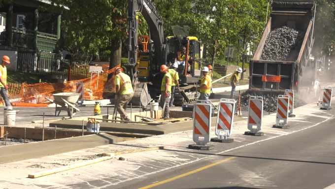 Construction workers dumping gravel on Atherton Street