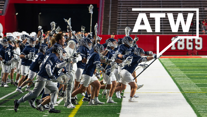 Penn State men's lacrosse players charge the field in celebration.