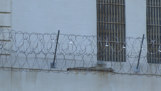 Barb wired fence surrounding correctional facility