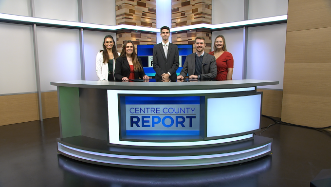 Five Centre County Anchor and reporters behind their news anchor desk