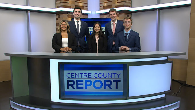 Four Centre County Report anchors standing behind the Centre County Report desk