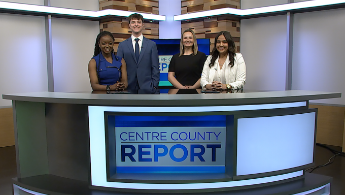 Four Centre County Anchors standing behind the Centre County Report anchor desk