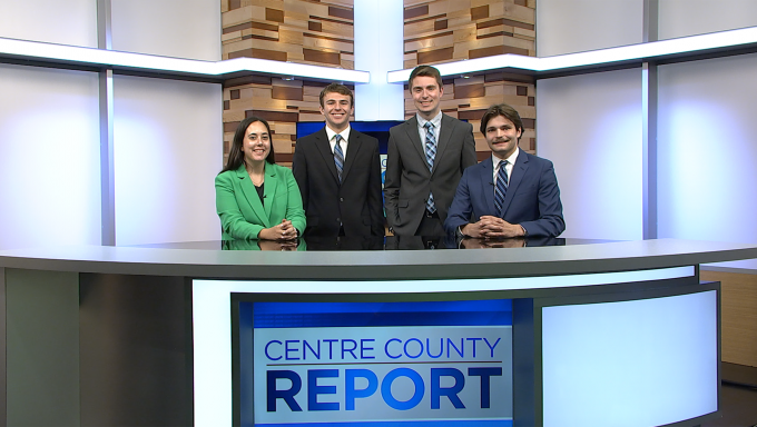 Four Centre County Report anchors standing behind the Centre County Report anchor desk