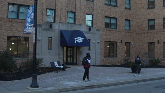 people walking in front of the Scholar Hotel in downtown State College