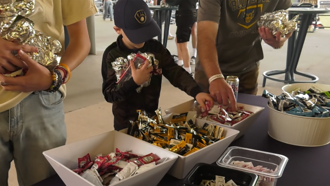 Penn State fan & kid grabbing ketchup for their hotdogs at Lubrano Park