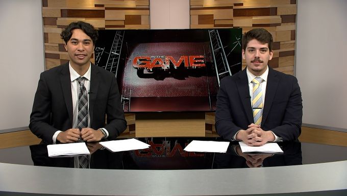 Two Bellisario Students, Cole Koffler and Jon Draeger, sit at the anchor desk for In The Game