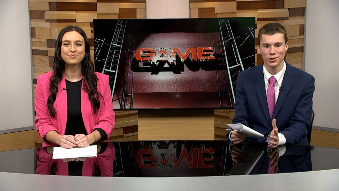 Two Bellisario College of Communications students, Emma Aken and Will Duerksen, sit at the anchor desk to host the show