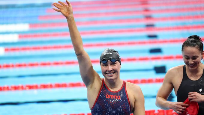 Swimmer waves to crowd