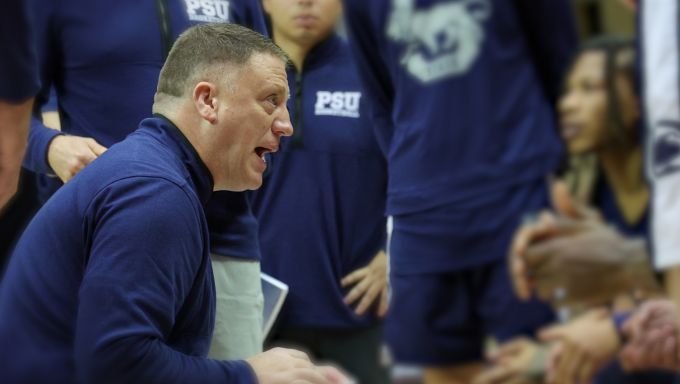 Mike Rhoades talks to his Penn State basketball team during a game.