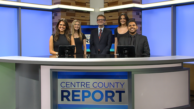 Five Centre County Report anchors standing behind a news desk
