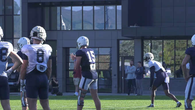 A photo of quarterback Drew Allar preparing to receive a football snap.