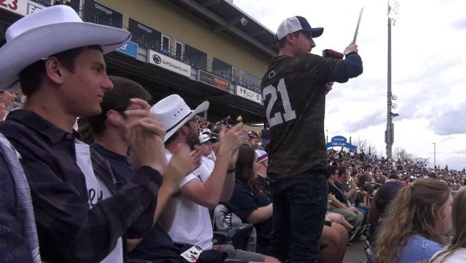 Penn State baseball fans cheer and hit a cowbell in the crowd at Medlar Field.