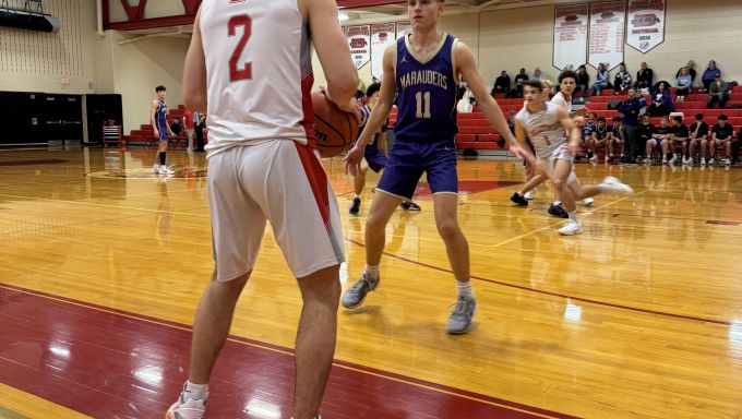 two basketball players inbounding the ball