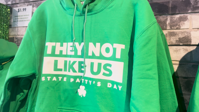 Green hoodie that reads "They not like us State Patty's Day"