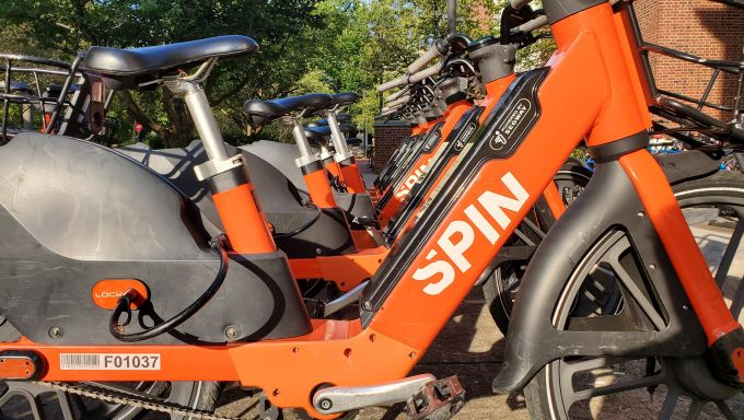 A row of SPIN Bicycles parked neatly.