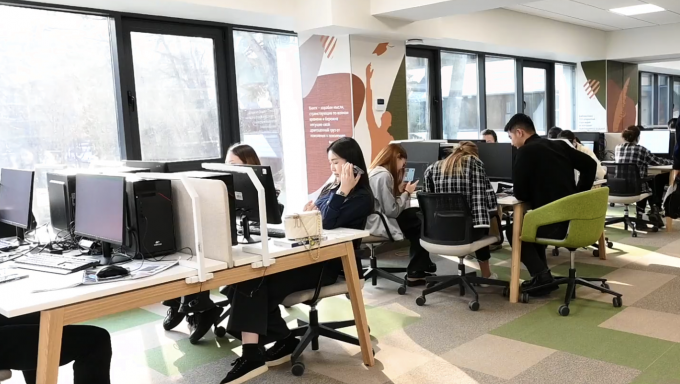 Students study at the computers in the open lab at Narxoz