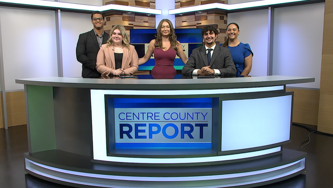 Anchors behind the Centre County Report news desk