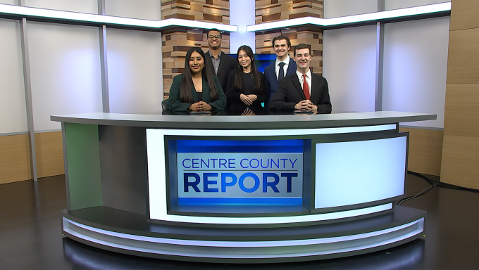 Five Centre County Report anchors standing behind the Centre County Report anchor desk