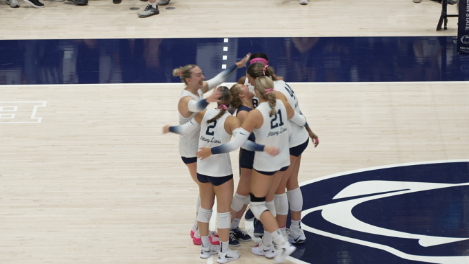 Penn State women's volleyball players celebrate after a successful point