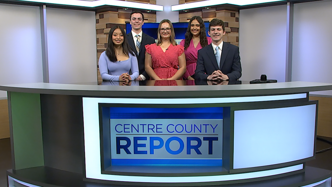 Five Centre County Report anchors standing behind the Centre County Report anchor deskt