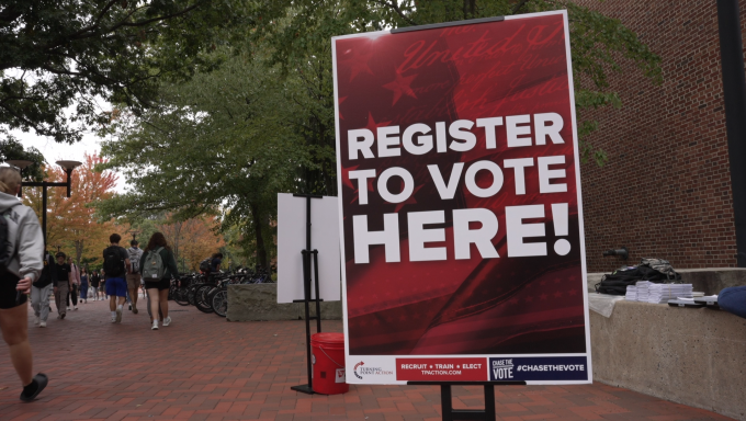 Large red banner that says Register to Vote Here