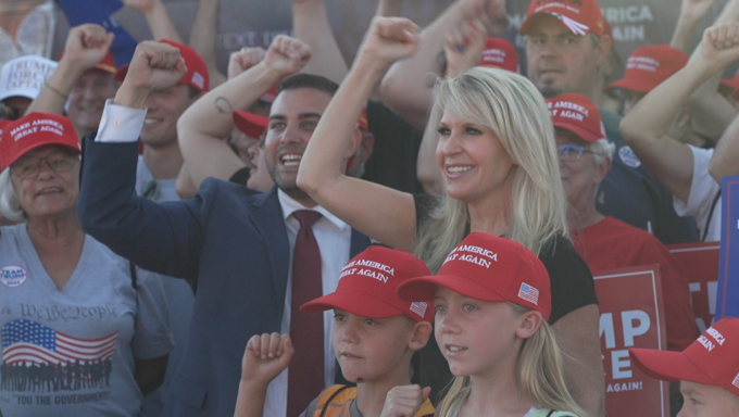 People cheer at a rally