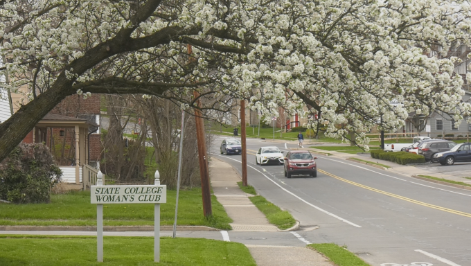 Three cars pass by the State College Woman's Club