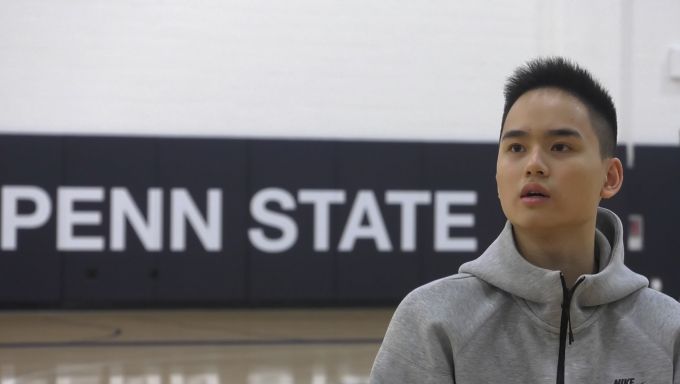 Penn State basketball manager Arthur Chou thinks about his answer while being interviewed on-camera.