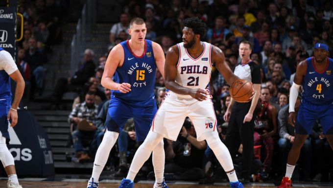 Joel Embiid backing down Nikola Jokic