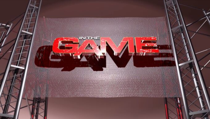 In The Game logo features the word game in red, three-dimensional letters on a backdrop that looks like a protective baseball screen hung between two uprights.