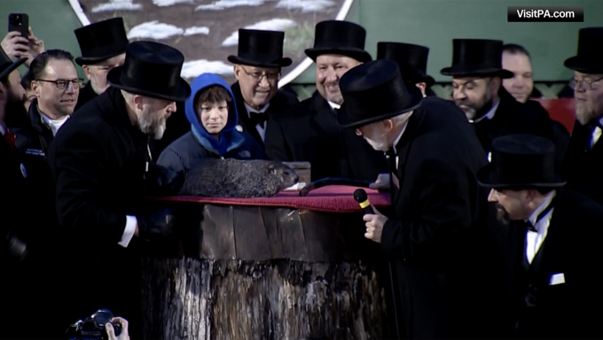 Members of the Inner CIrcle watch as the groundhog Punxsutawney Phil makes his weather prediction