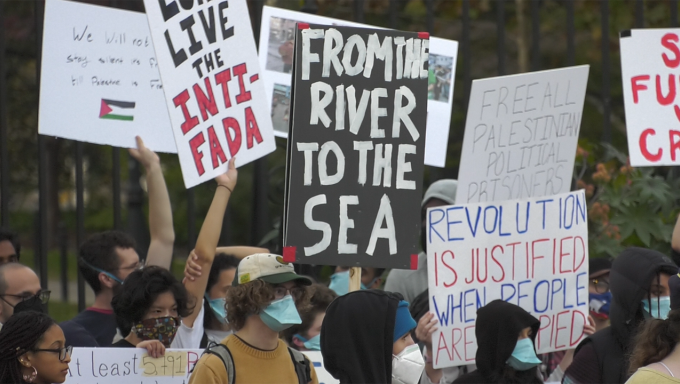 Poster that read "From river to the sea" is seen in the middle of the image during the Week of Action for Palestine in State College