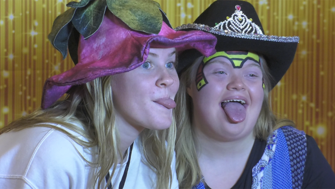 Two friends posing in a Photo Booth