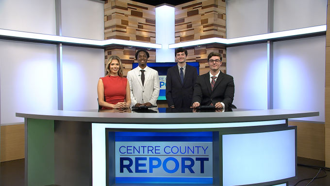 Four Centre County Report anchors standing behind their desk.