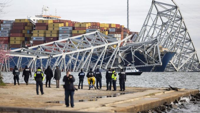 Officials look on at some of the remains of the Francis Scott Key Bridge