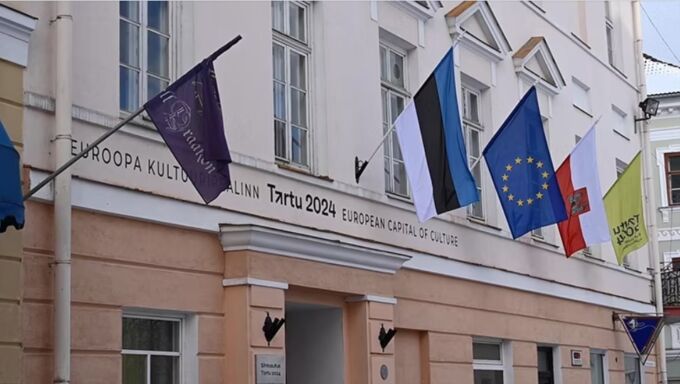 International flags flying on the front of a building signed Tartu 2024