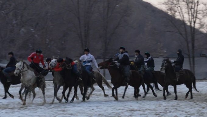 Kazakh horseback riders playing a game