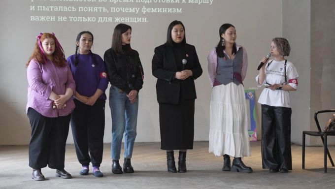 A group of women in Kazakhstan speaking at an event for domestic violence awareness